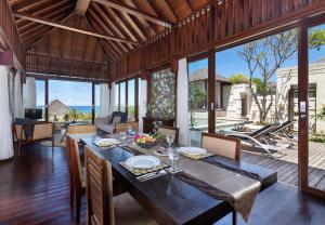 a dining room with a table in a villa at The Chand's Boutique Villas by Villa Finder in Seminyak