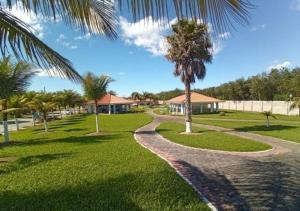 a walkway in a park with a palm tree at Recanto de Araruama in Araruama