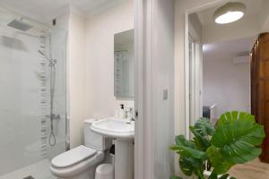 Baño blanco con aseo y lavamanos en Apartamento El Equilibrio, en Playa Honda