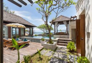a backyard with a swimming pool and a house at The Chand's Boutique Villas by Villa Finder in Seminyak