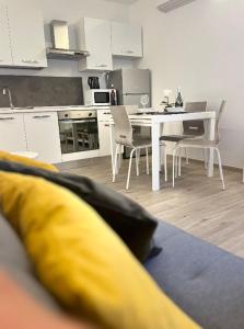 a kitchen and dining room with a table and chairs at Alkecè White in Udine