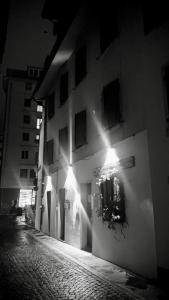 a building with lights on the side of a street at Alkecè White in Udine