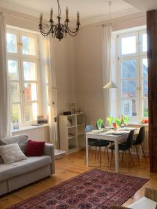 a living room with a couch and a table with chairs at Schloss Lelkendorf, Fewo Hoppenrade in Lelkendorf