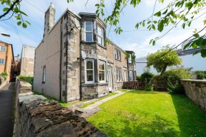 an old stone house with a green yard at Heritage Quarter in Fife