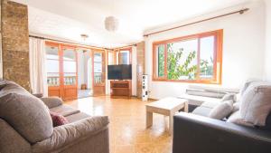 a living room with two couches and a tv at Na Penyal Ref 246 in Cala Millor
