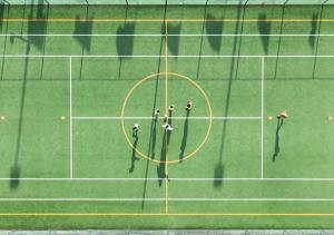 a group of people standing on a tennis court at Santamaria Village Resort Ascea in Ascea