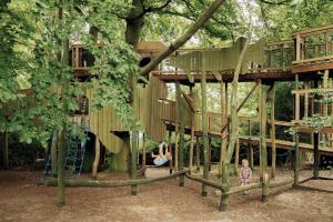 a child playing in a tree house at Fritton Lake - The Clubhouse in Great Yarmouth