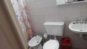 a bathroom with a toilet and a sink at La Trinidad San Luis, La Punta in La Punta