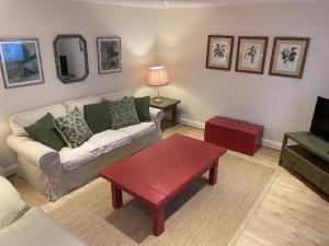 a living room with a couch and a coffee table at Far Hill Cottage in Wyck Rissington