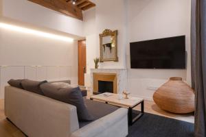 a living room with a couch and a fireplace at MiHotel Georges in Lyon