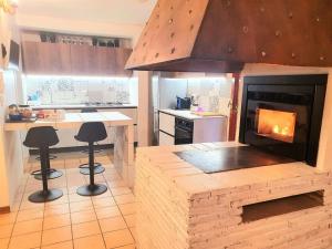 a kitchen with a fireplace in a kitchen with stools at Villa D'Amare in Riccione