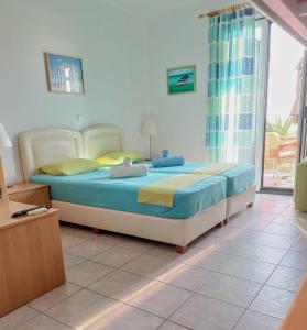 1 dormitorio con 1 cama en una habitación con ventana en Studios Edem en Agios Ioannis Kaspaka
