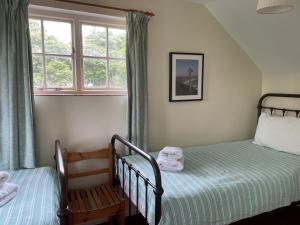 En eller flere senge i et værelse på Orchard Cottage