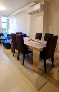 a dining room with a wooden table and chairs at Ain Sokhna 'Cosmopolitan'- Half-Board in Ain Sokhna