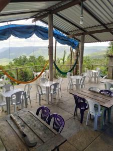 a group of tables and chairs on a patio at Cabana King BioReserva Park in Tianguá