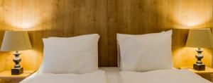 A bed or beds in a room at The Museum Living Budapest