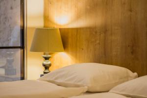 A bed or beds in a room at The Museum Living Budapest