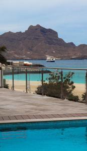 a swimming pool with a view of the beach and the ocean at Luna Boutique Hotel in Mindelo