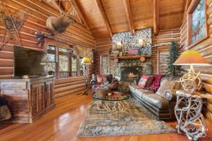 a living room with a couch and a fireplace at Cinnamon Valley in Eureka Springs