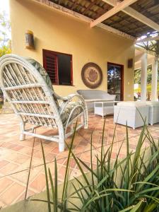 a white chair sitting on the patio of a house at Pousada e Bistrô Estância Monte Horebe in Mulungu