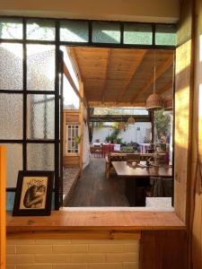 a view of the dining room and kitchen of a house at Mucho Bonito Hostel in Santa Fe