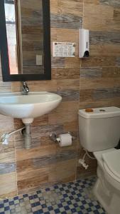La salle de bains est pourvue d'un lavabo et de toilettes. dans l'établissement Senderito cafetero, à Ruiosucio