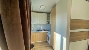 a small kitchen with a sink and a stove at Apartment City Center in Klaipėda