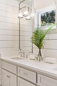 a bathroom with a sink and a mirror at Anastasia’s Burrow - 629 Oak St in Demere Park +33 photos