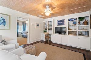 a living room with white furniture and a ceiling fan at Anastasia’s Burrow - 629 Oak St in Demere Park
