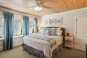 a bedroom with a bed and a ceiling fan at Anastasia’s Burrow - 629 Oak St in Demere Park