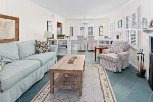 a living room with a couch and a table at Latitude Adjustment - 4311 Ninth Street in Saint Simons Island