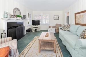 a living room with a couch and a table at Latitude Adjustment - 4311 Ninth Street in Saint Simons Island