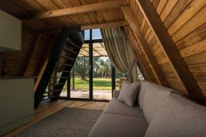 a living room with a couch and a wooden ceiling at Byelka Bungalov Ayvalık in Ayvalık