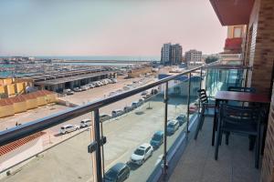 a balcony with a view of a parking lot with cars at ANCLA spaces EGVT-436-CS in Vinaròs
