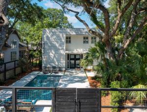 a house with a swimming pool and a fence at Zen-N-Sea - 4222 Third St in Saint Simons Island