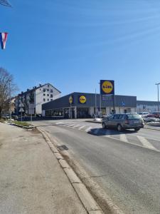 a car parked in front of a store on a street at Apartment Pemper - Self check in and check out in Otočac