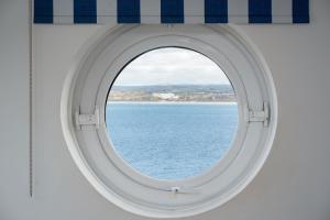 anorthole of an airplane window looking out at the ocean at Number One - Stones Court in St Ives