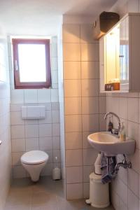 a small bathroom with a toilet and a sink at Panorama Family House in Palekastron +53 photos