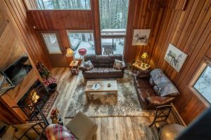 an overhead view of a living room with leather furniture at Escape to Ptarmigan Village 103 in Whitefish