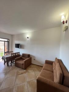 a living room with a couch and a table at Kamberi Hotel & Apartments 2 in Velipojë