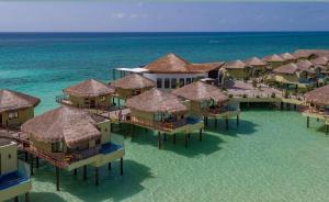 an aerial view of a resort on the beach at Palafitos Overwater Bungalows El Dorado Maroma - Adults Only in Playa del Carmen