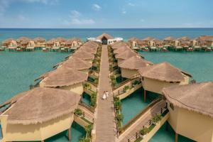 an aerial view of a resort in the water at Palafitos Overwater Bungalows El Dorado Maroma - Adults Only in Playa del Carmen