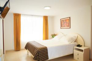 Postel nebo postele na pokoji v ubytování Astorga Hotel Arequipa