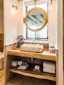 a bathroom with a sink and a mirror at Naay Boutique Hotel Holbox in Holbox Island