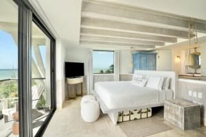 Postel nebo postele na pokoji v ubytování Naay Boutique Hotel Holbox