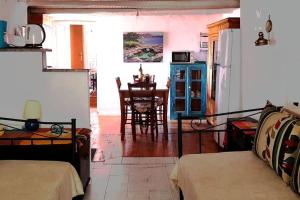 a living room with a bed and a dining room at MARIA'S Rustic stonehouse in traditional village in Koúmani