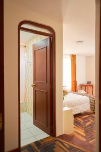 Postel nebo postele na pokoji v ubytování Astorga Hotel Arequipa