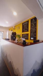 a bar with signs on the wall of a restaurant at Mora Hostel in Mendoza