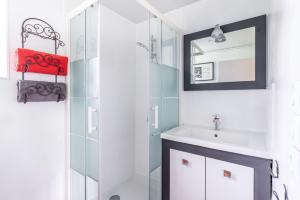 a bathroom with a sink and a mirror at La Villauvert - Cottage in Saint-Martin-sur-Oust