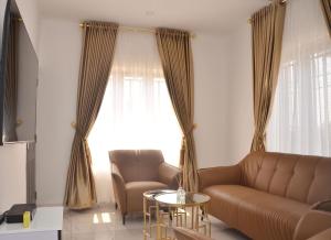 a living room with a couch and a table at Jama Residence in Abuja